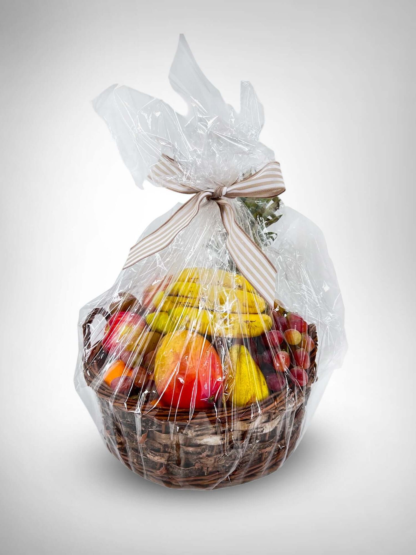 A beautifully wrapped Fruit Basket with seasonal fruits, perfect for gifting any occasion. Flowers optional from local florist.
