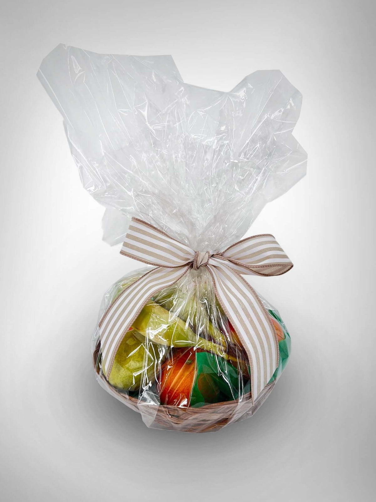 Seasonal Fruit Basket wrapped with clear plastic and a ribbon, perfect gift from a local florist in Canton.