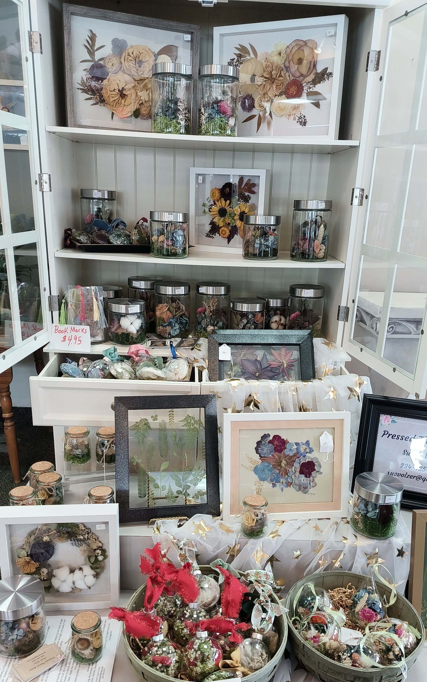 Terrarium Ornament display featuring preserved flowers, flower arrangements, and decorative botanicals at a local florist.