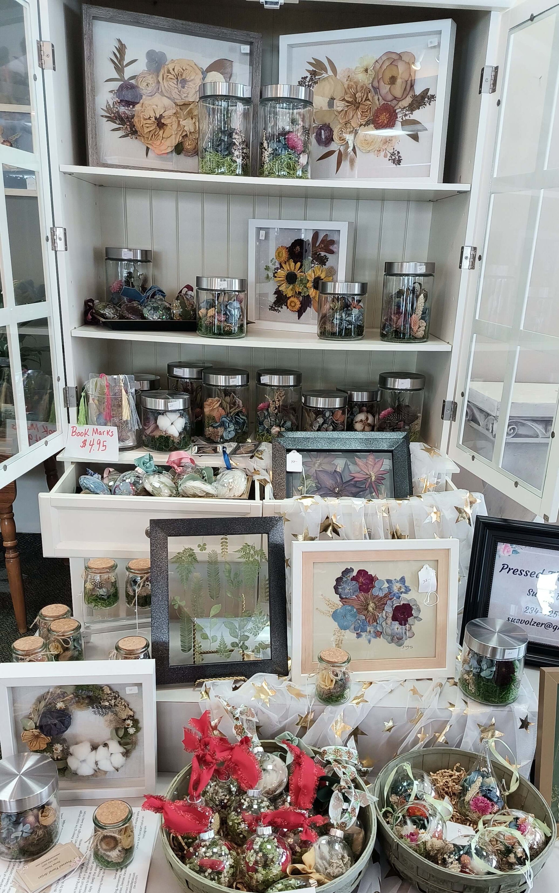 Terrarium Ornament display featuring preserved flowers, flower arrangements, and decorative botanicals at a local florist.
