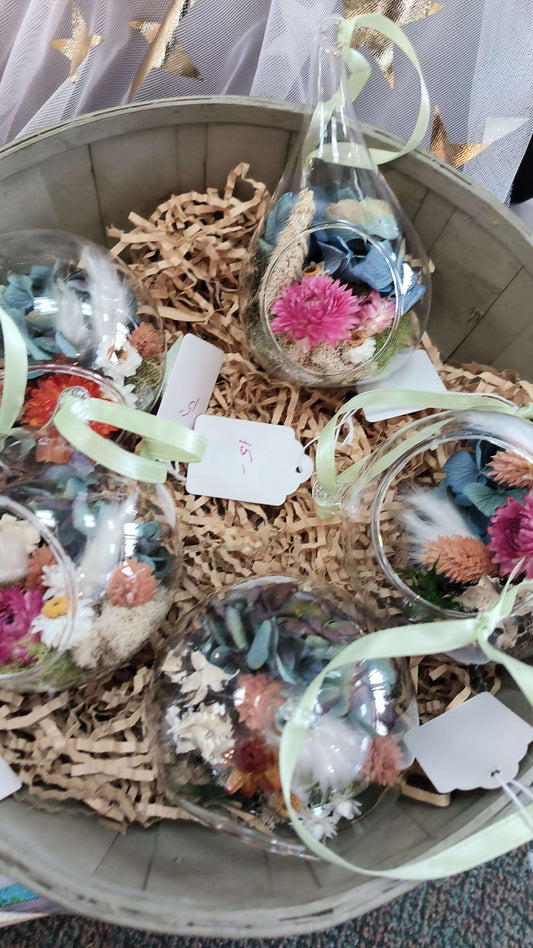 Terrarium Ornament glass teardrop filled with dried flowers in a decorative basket, perfect for local florist arrangements.
